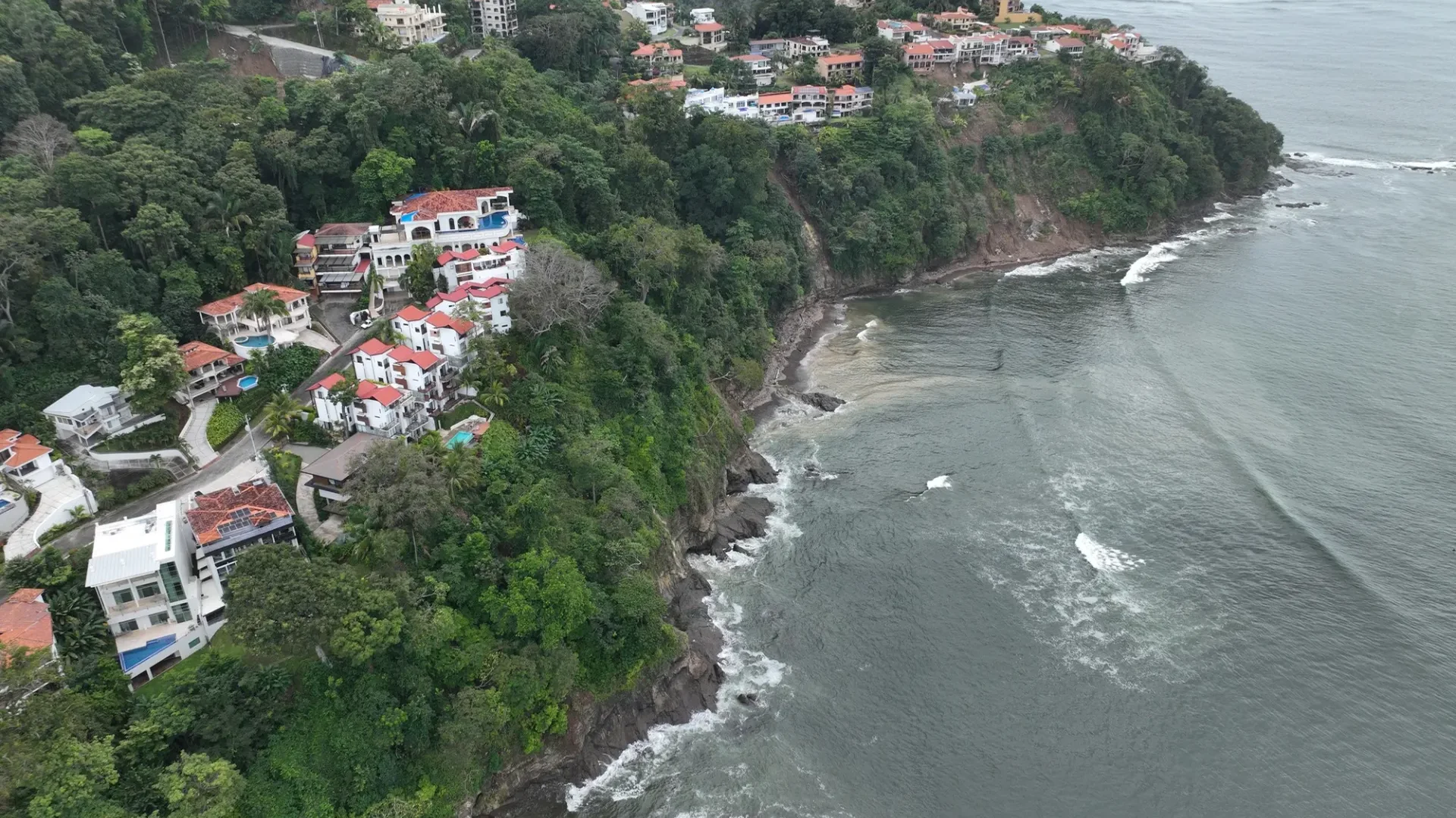 Guided 4x4 & ATV adventure crossing a Costa Rica rainforest river with waterfall backdrop